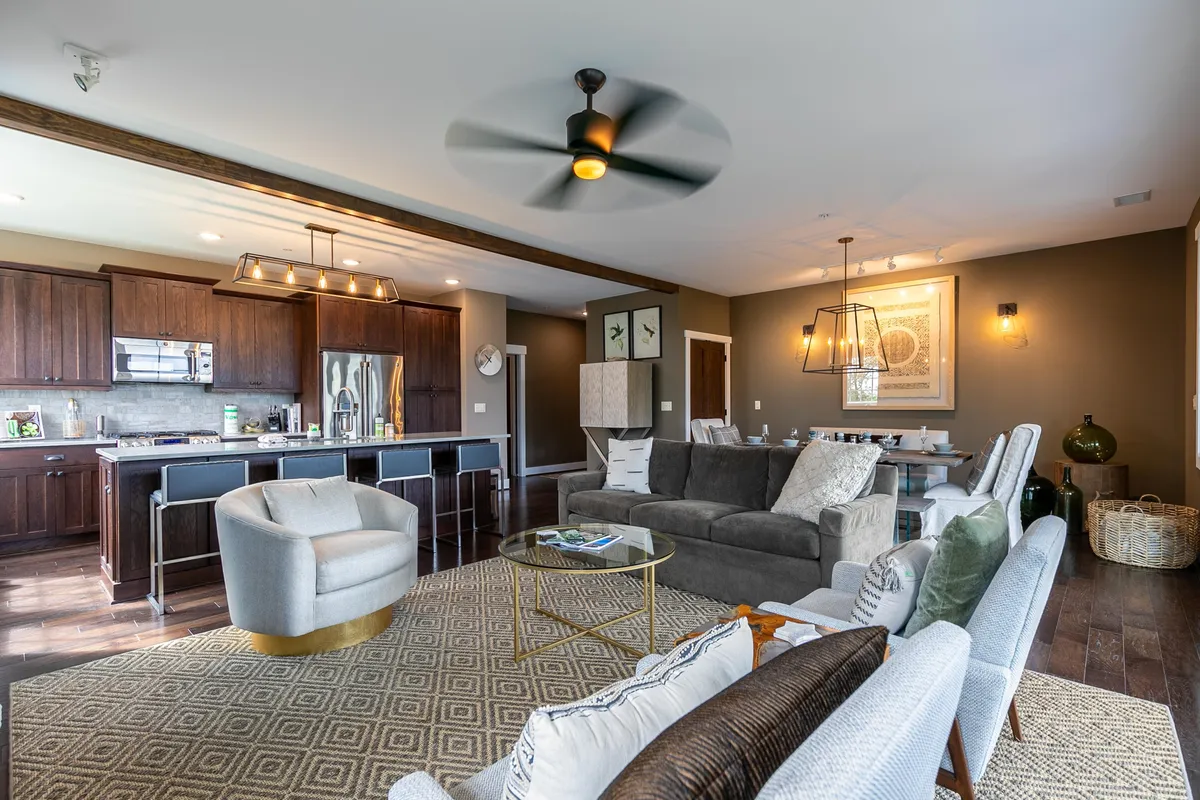 A welcoming and modern kitchen area with a seating arrangement, decorative artwork on the walls, and stylish lighting fixtures. The space is open and functional, perfect for both quick meals and socializing. The layout and finishes convey a sense of effortless everyday living and comfort.